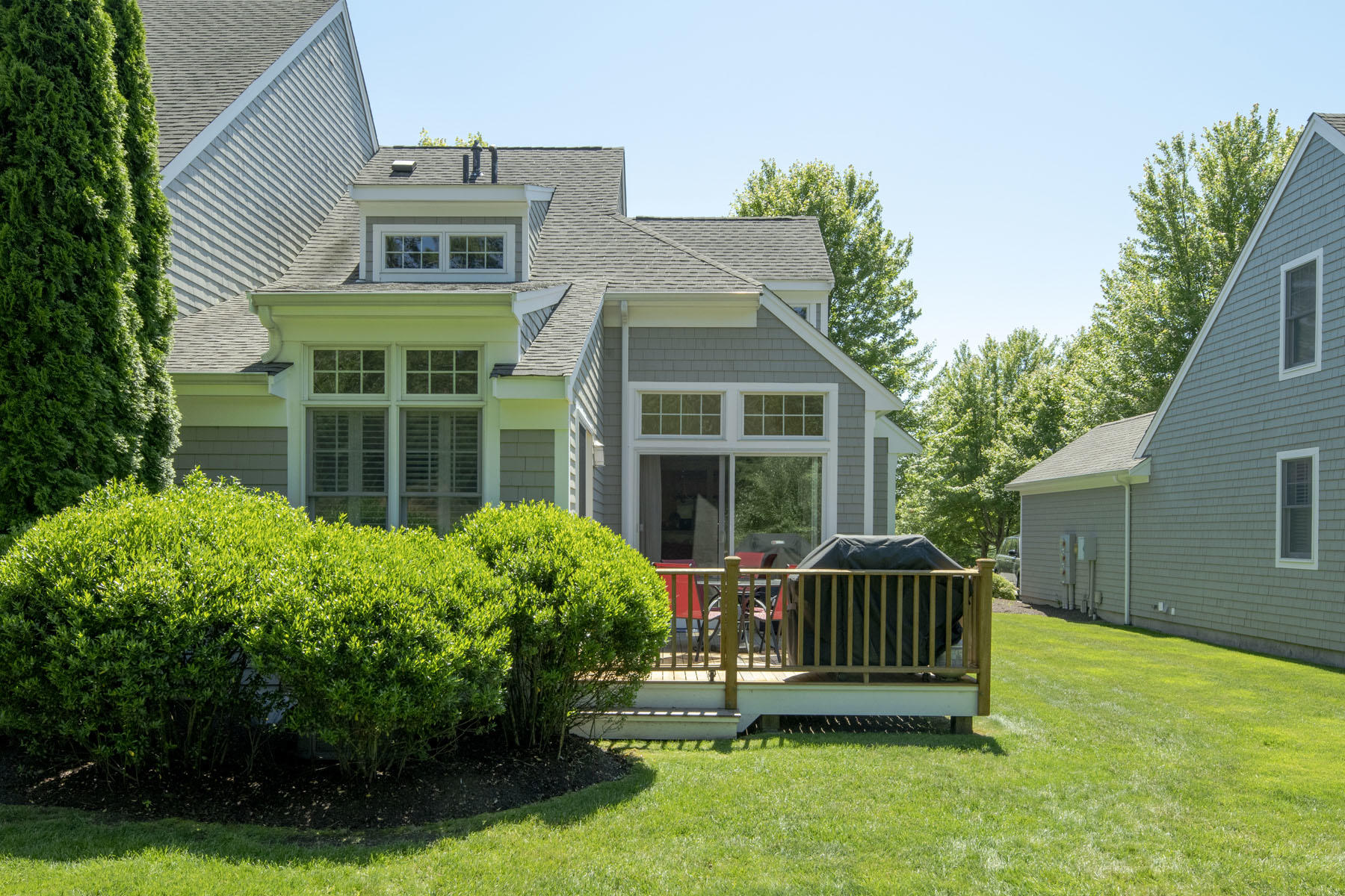 a view of a house with a deck and a yard