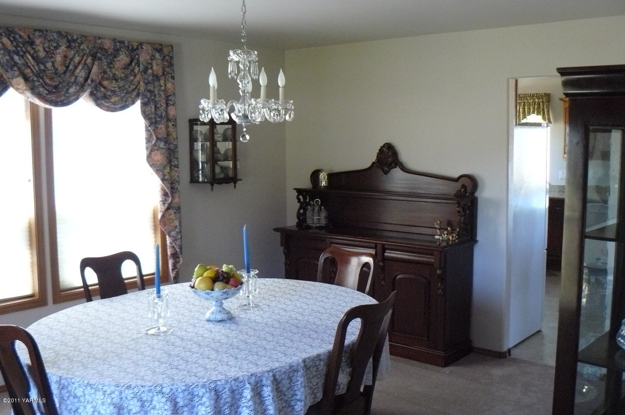 12074 Mieras Road Moxee, WA 98936 - Photo 4 of 22 a kitchen with a table chairs and refrigerator