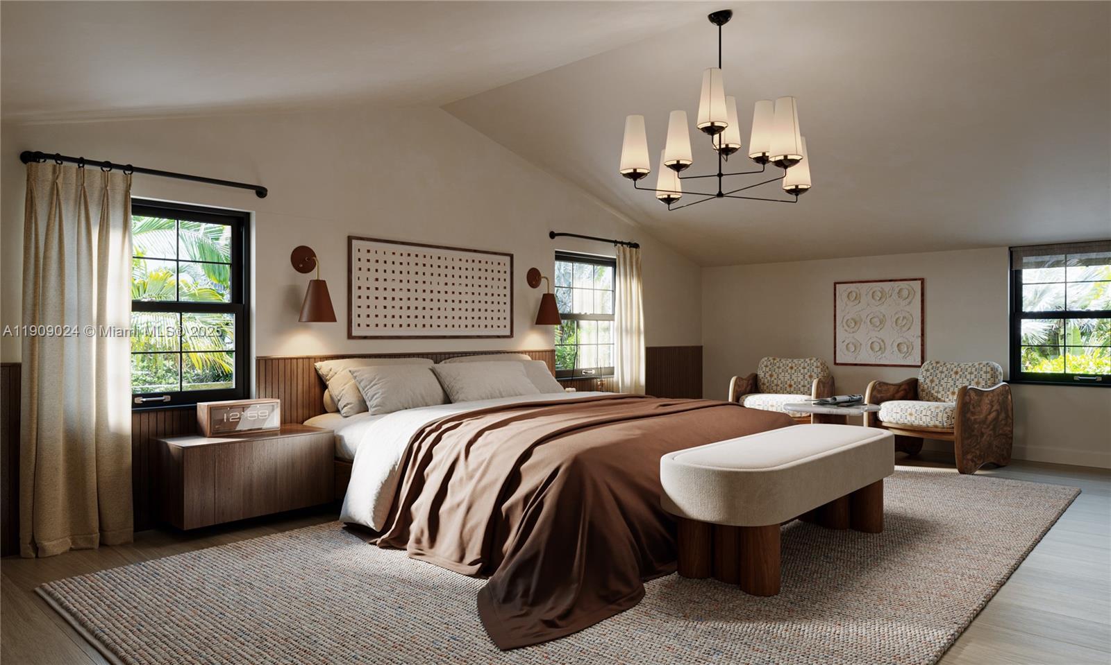 4727 North Bay Road Miami Beach, FL 33140 - Photo 11 of 15 a spacious bedroom with bed and a chandelier