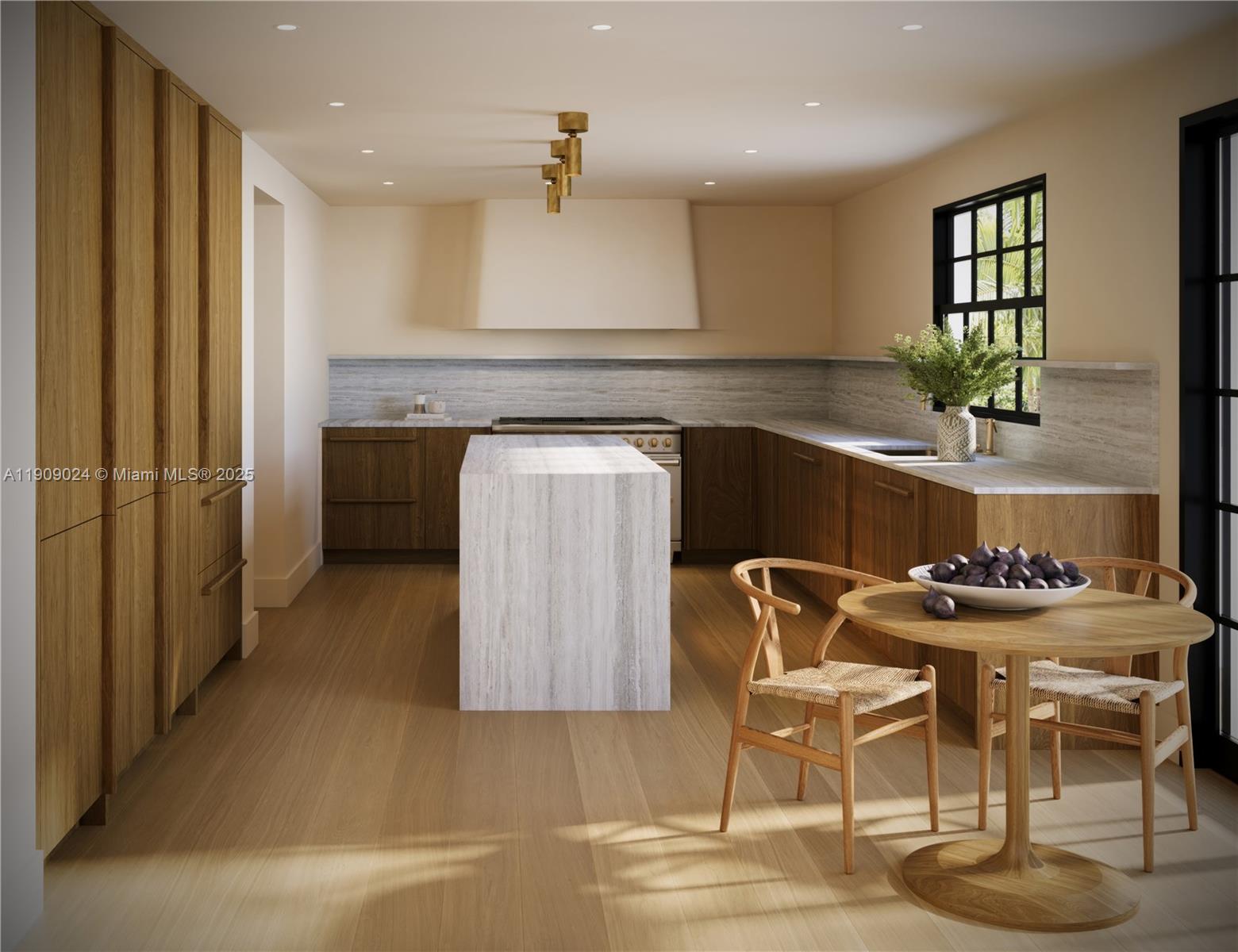 4727 North Bay Road Miami Beach, FL 33140 - Photo 14 of 15 a kitchen with stainless steel appliances kitchen island granite countertop a table and chairs in it