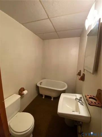 a bathroom with a sink a toilet and mirror
