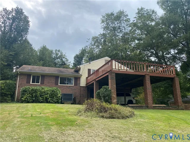 a view of a house with a yard potted plants and a table