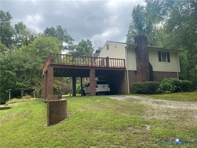 a view of a house with a yard and sitting area
