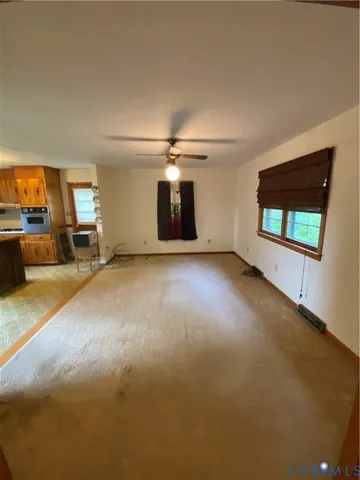 a view of a livingroom with furniture wooden floor and window