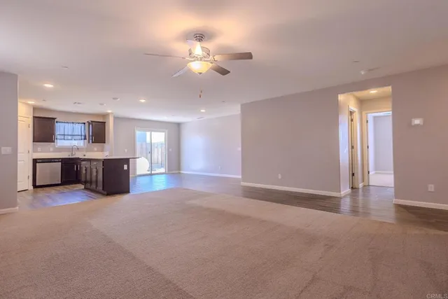 a large room with a chandelier and a kitchen