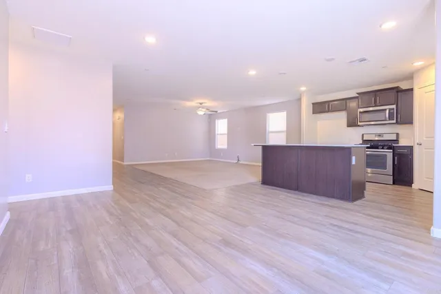 a view of kitchen and kitchen with wooden floor