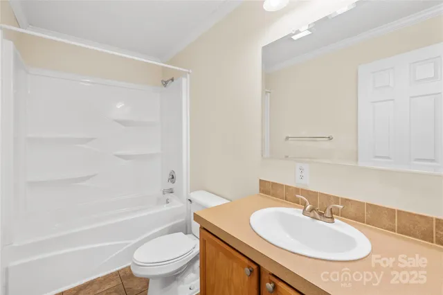 a bathroom with a granite countertop sink toilet a mirror and shower