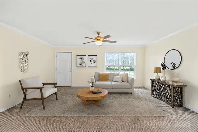 a living room with furniture a rug and a window