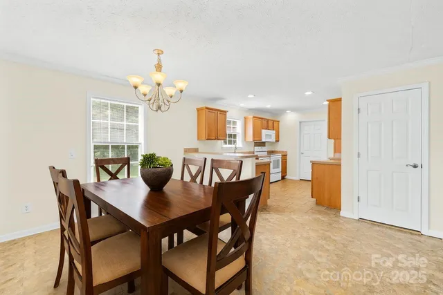 a view of a dining room with furniture and chandelier