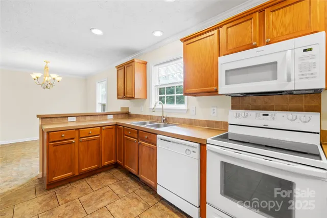 a kitchen with granite countertop cabinets stainless steel appliances and a counter space