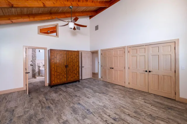 a view of a room that has a window and wooden floor