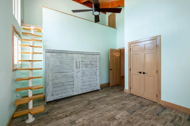 a kitchen with granite countertop a stove and a white cabinets