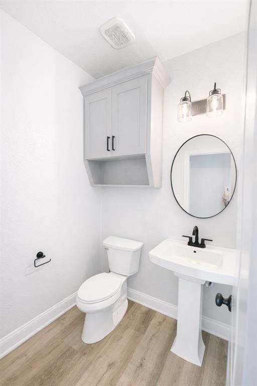 224 Fox Run Lane Robinson, TX 76706 - Photo 22 of 24 a bathroom with a toilet a sink and mirror