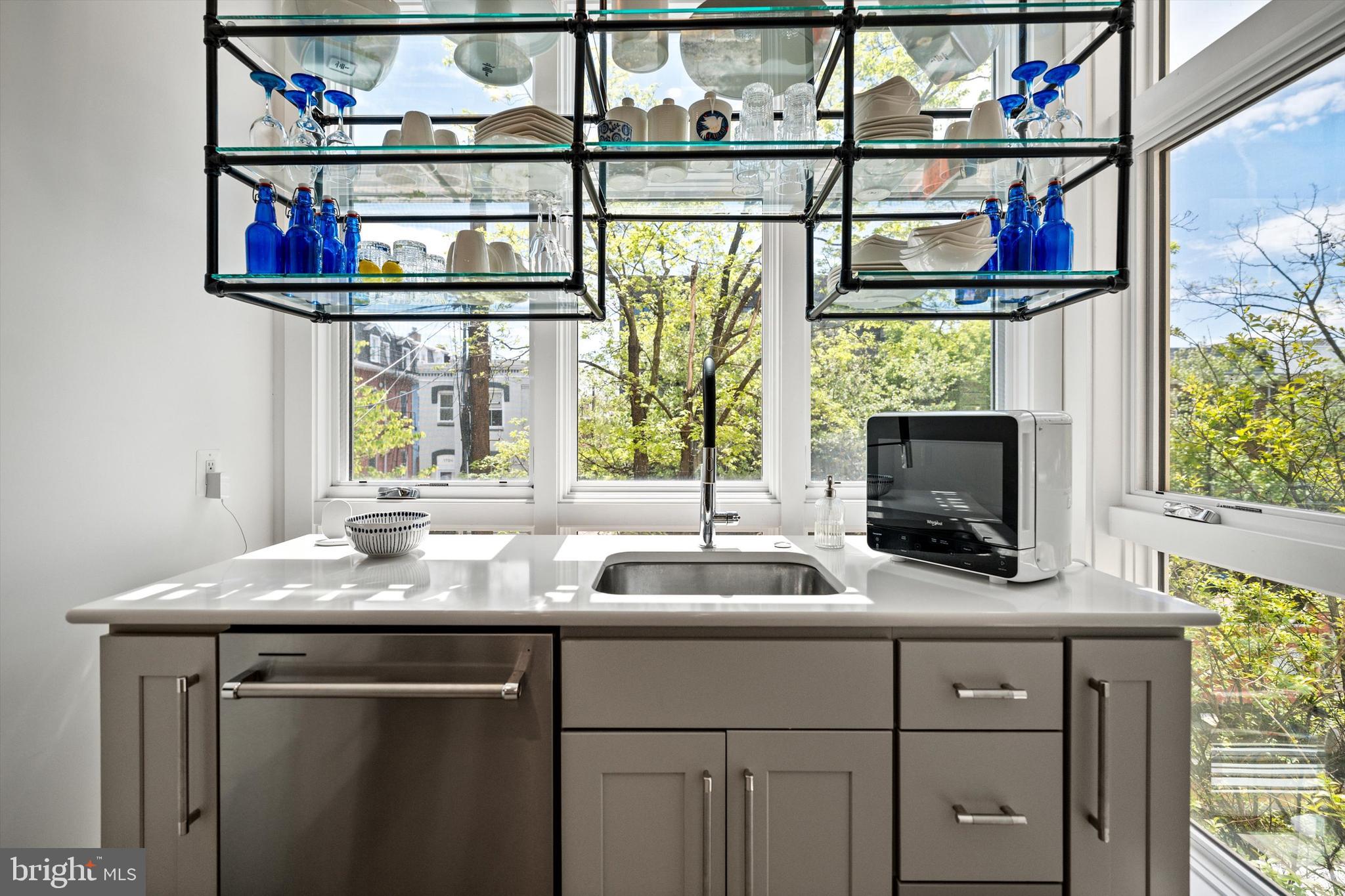 1717 V Street Northwest Washington, DC 20009 - Photo 18 of 40 a kitchen with a sink cabinets and a window