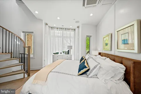 a spacious bedroom with a bed and a window