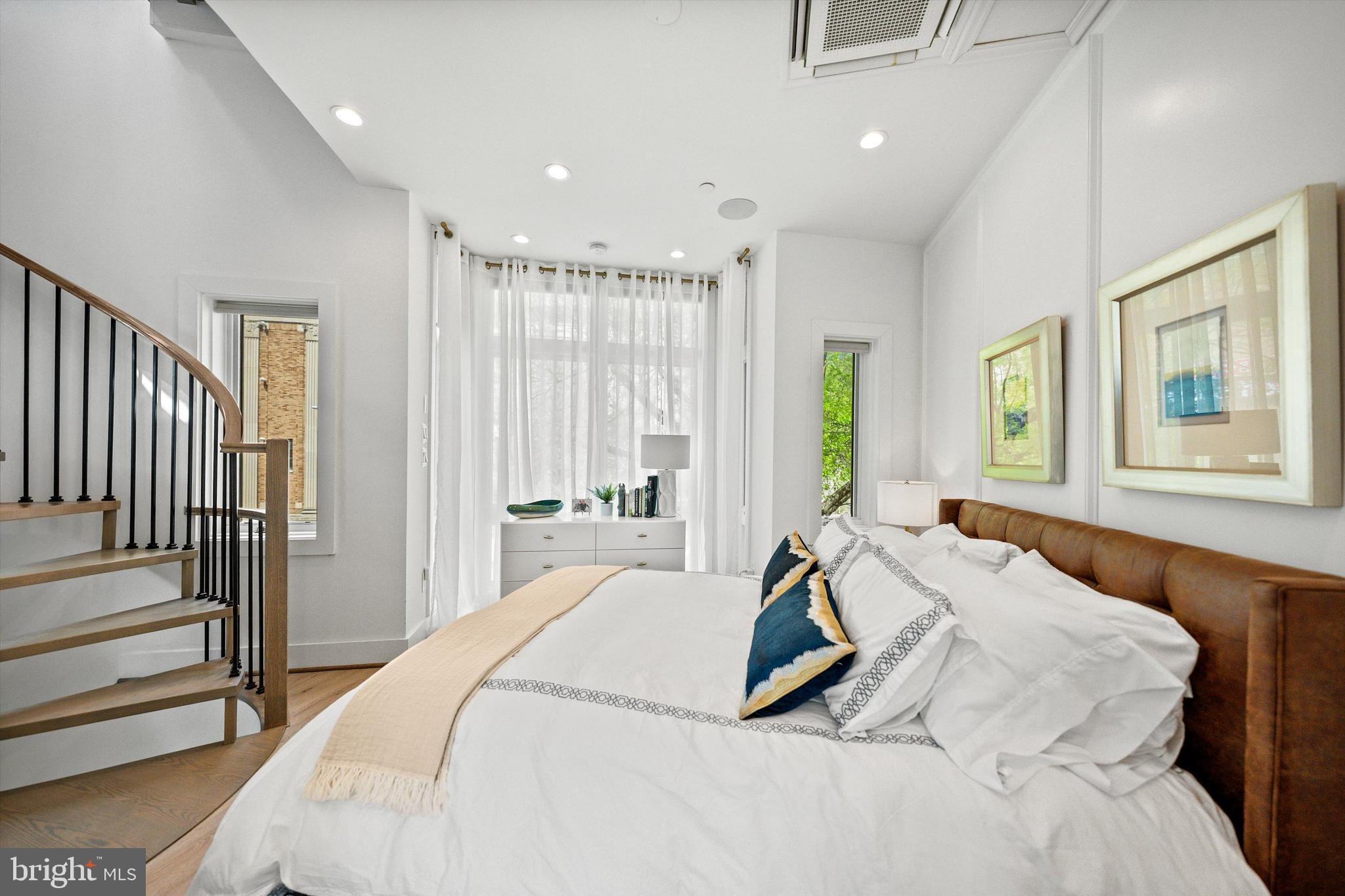 1717 V Street Northwest Washington, DC 20009 - Photo 22 of 40 a spacious bedroom with a bed and a window