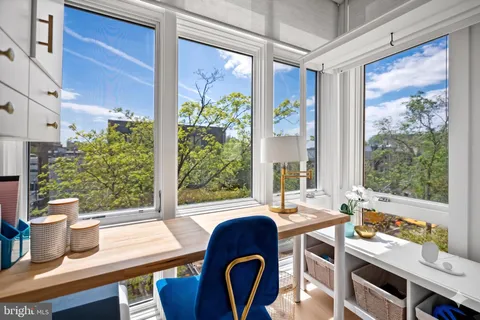 a dining table sitting next to a window