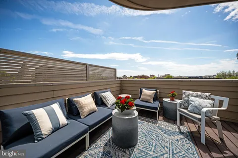 a view of a roof deck with furniture