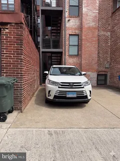 a car parked in front of brick building