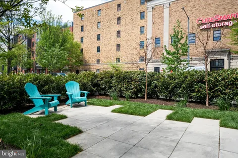 a view of a building with garden and sitting area
