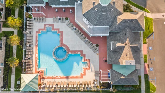 an aerial view of residential houses with outdoor space and parking