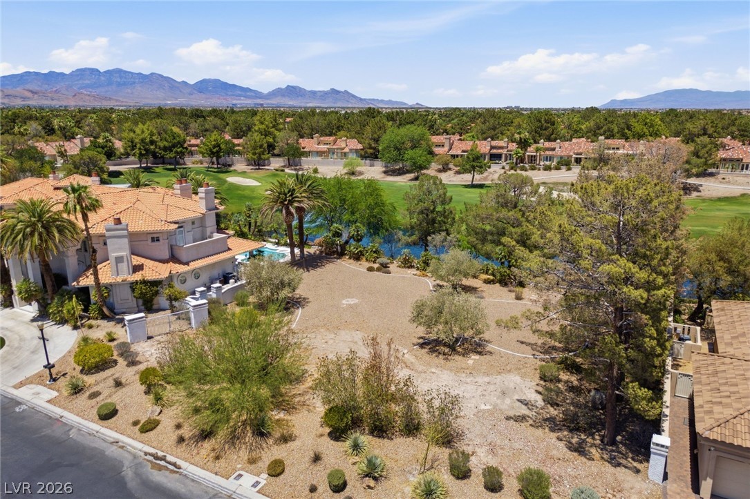20 Innisbrook Avenue Las Vegas, NV 89113 - Photo 8 of 39 An aerial perspective reveals a majestic property nestled beside a pristine golf course with a mountain backdrop.