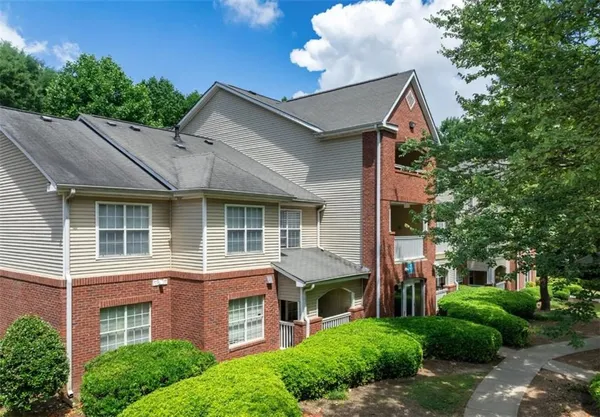 a front view of a residential apartment building with a yard