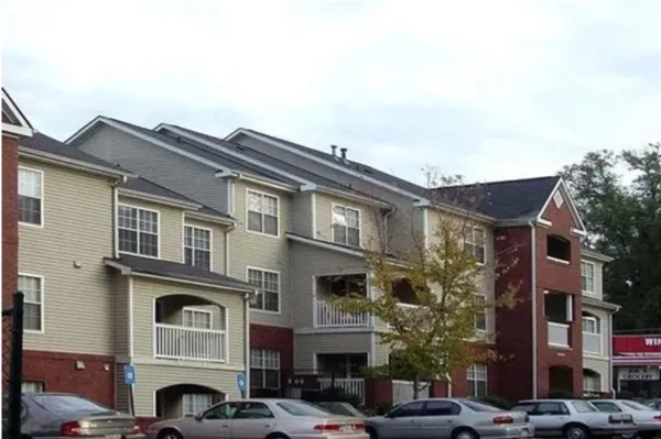 a front view of a residential apartment building with a yard