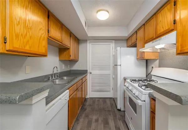 a kitchen with a sink stove and refrigerator