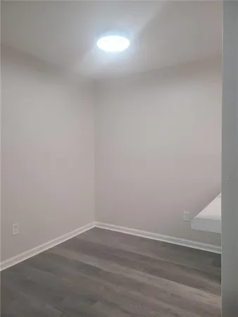 a view of an empty room and wooden floor