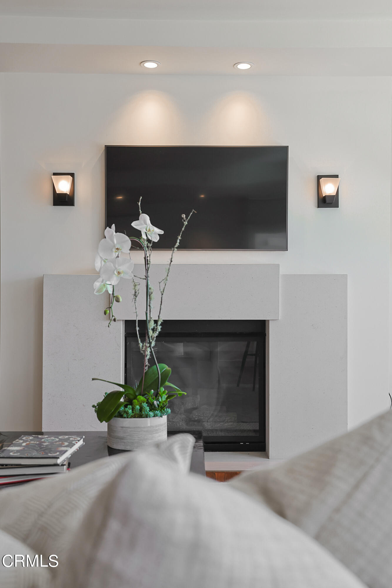 920 Granite Drive, Unit 509 Pasadena, CA 91101 - Photo 4 of 24 a living room with a fireplace a flat screen tv and a potted plant