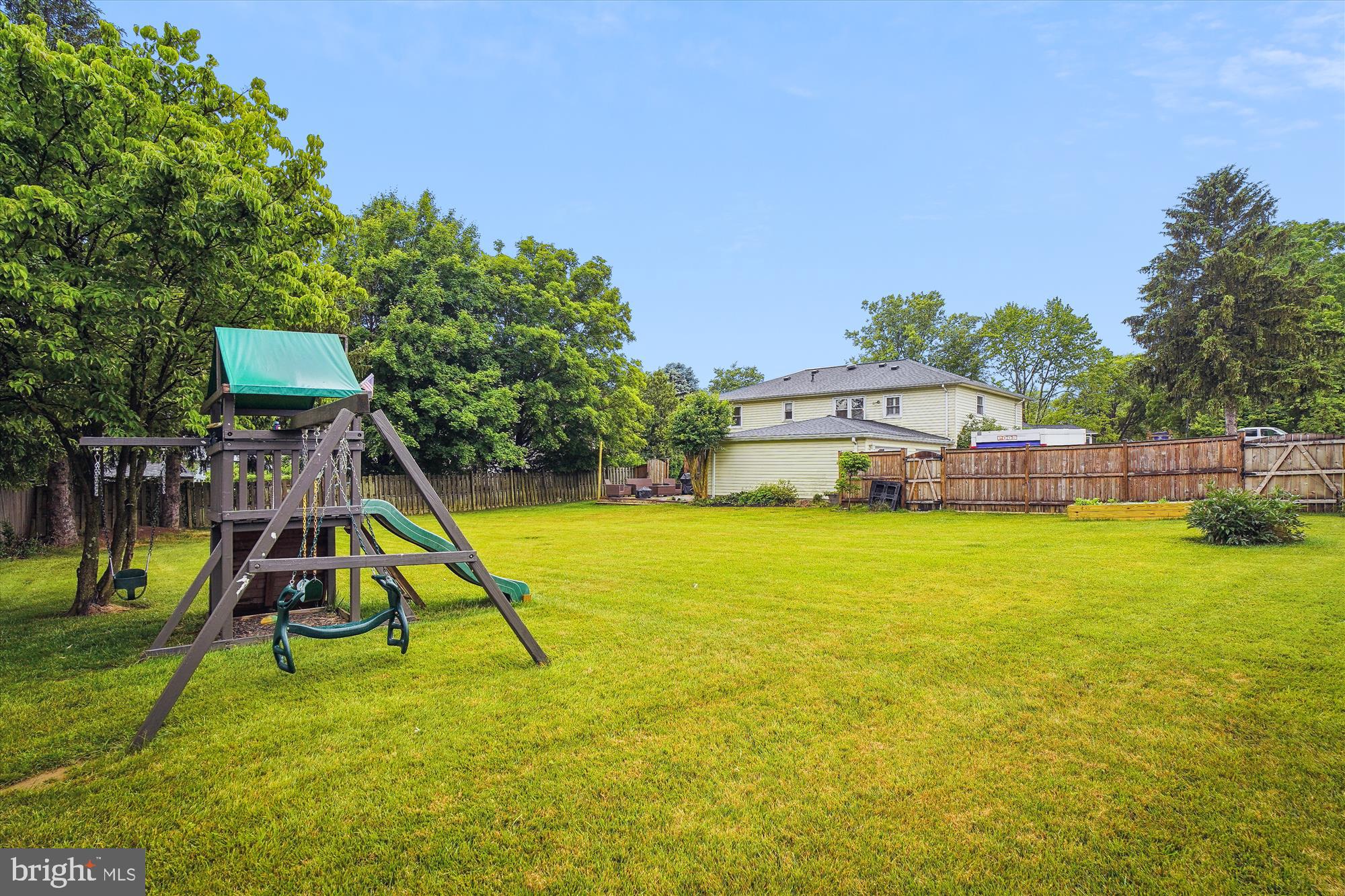 18709 Bloomfield Road Olney, MD 20832 - Photo 44 of 56 a view of a house with a swimming pool and a child park