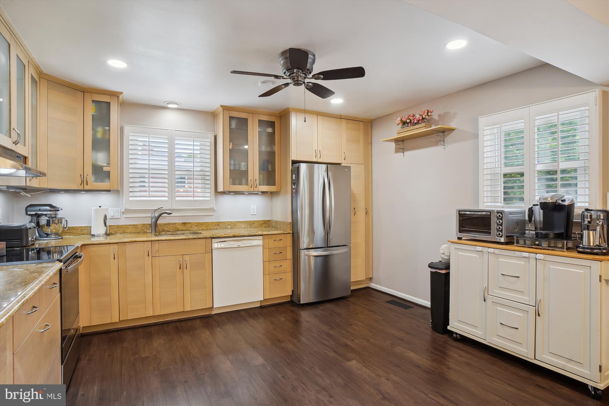 18709 Bloomfield Road Olney, MD 20832 - Photo 7 of 56 a kitchen with stainless steel appliances granite countertop a refrigerator a sink dishwasher a stove and white cabinets with wooden floor