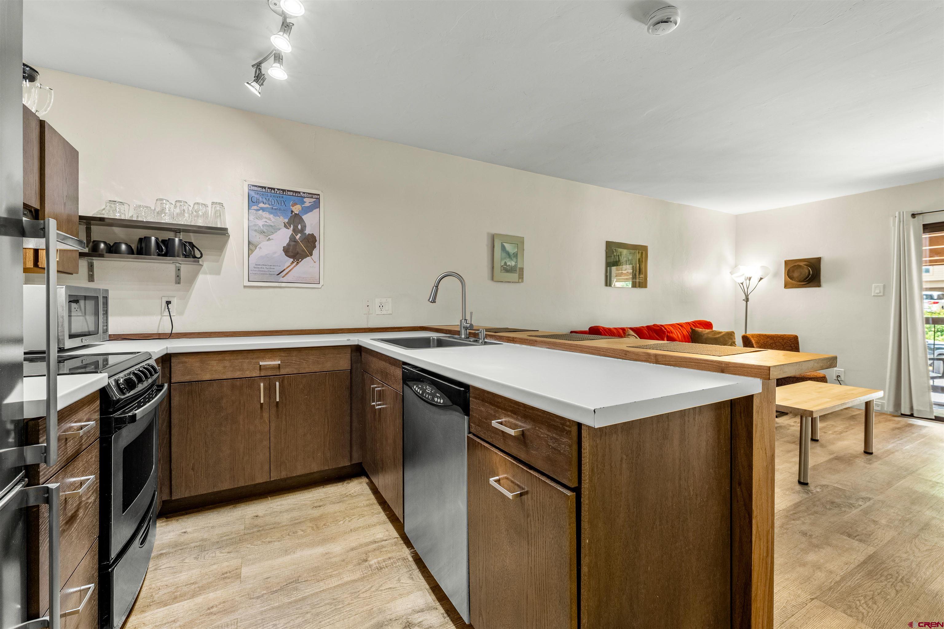 455 Sheol Street, Unit 209 Durango, CO 81301 - Photo 6 of 30 a kitchen with a sink stove and cabinets