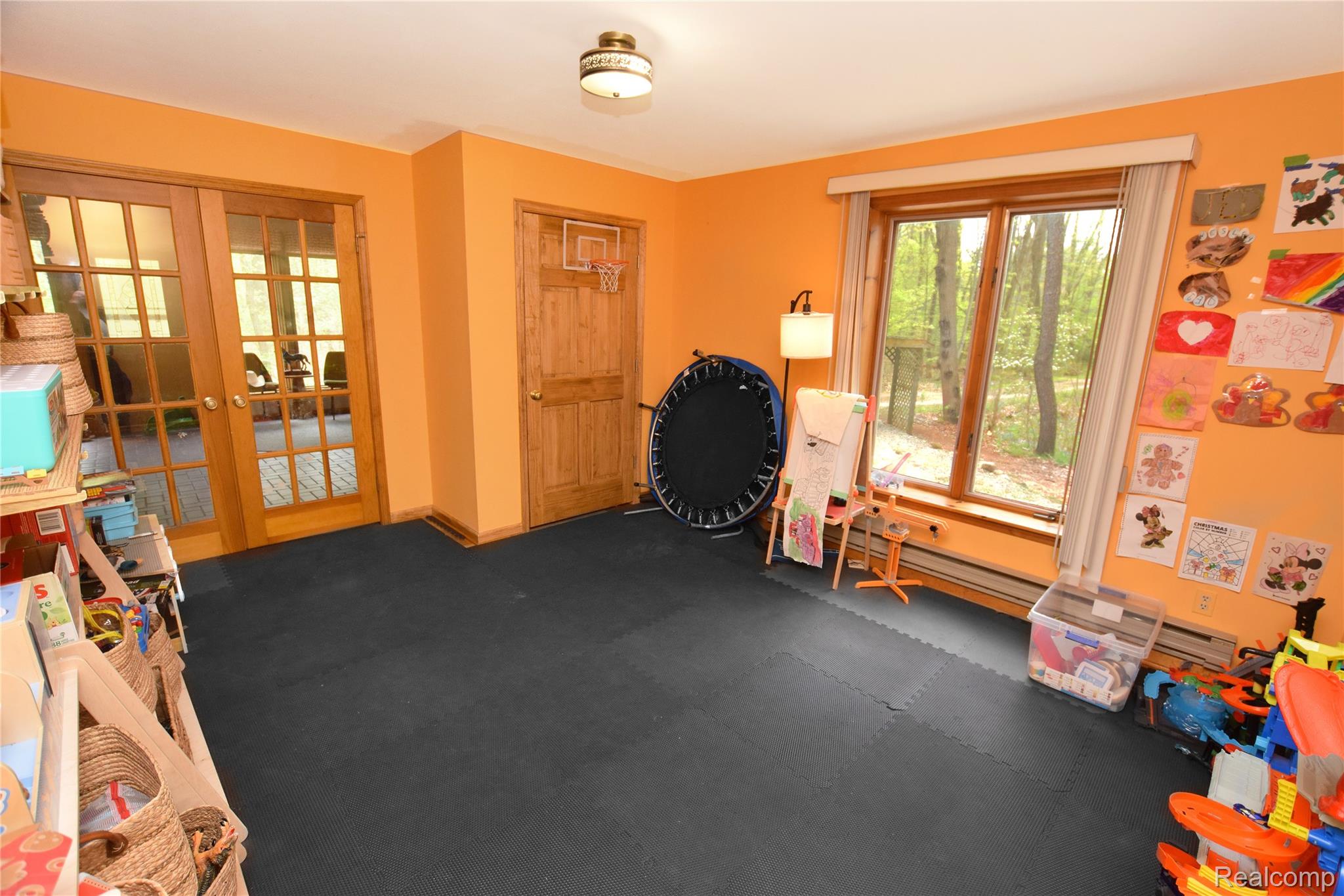 3910 Joy Road Metamora, MI 48455 - Photo 12 of 26 Recreation room featuring french doors, plenty of natural light, and baseboard heating