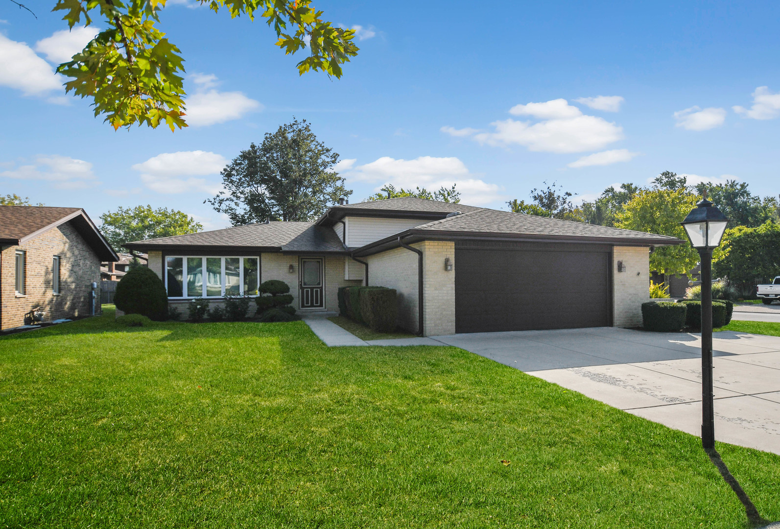 a front view of a house with a garden and yard