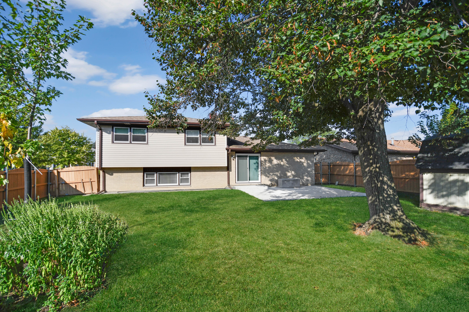 11201 Deerpath Lane Palos Hills, IL 60465 - Photo 20 of 25 a view of a white house with a big yard and large trees