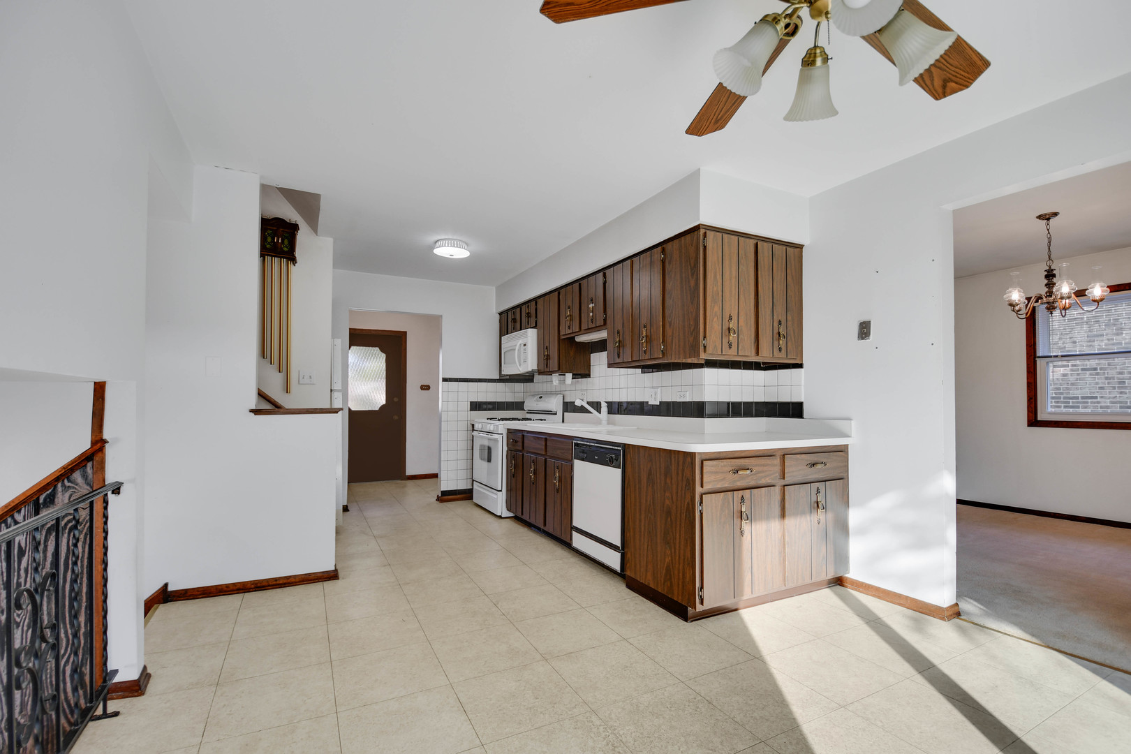 11201 Deerpath Lane Palos Hills, IL 60465 - Photo 9 of 25 a kitchen with stainless steel appliances a stove a microwave and white cabinets