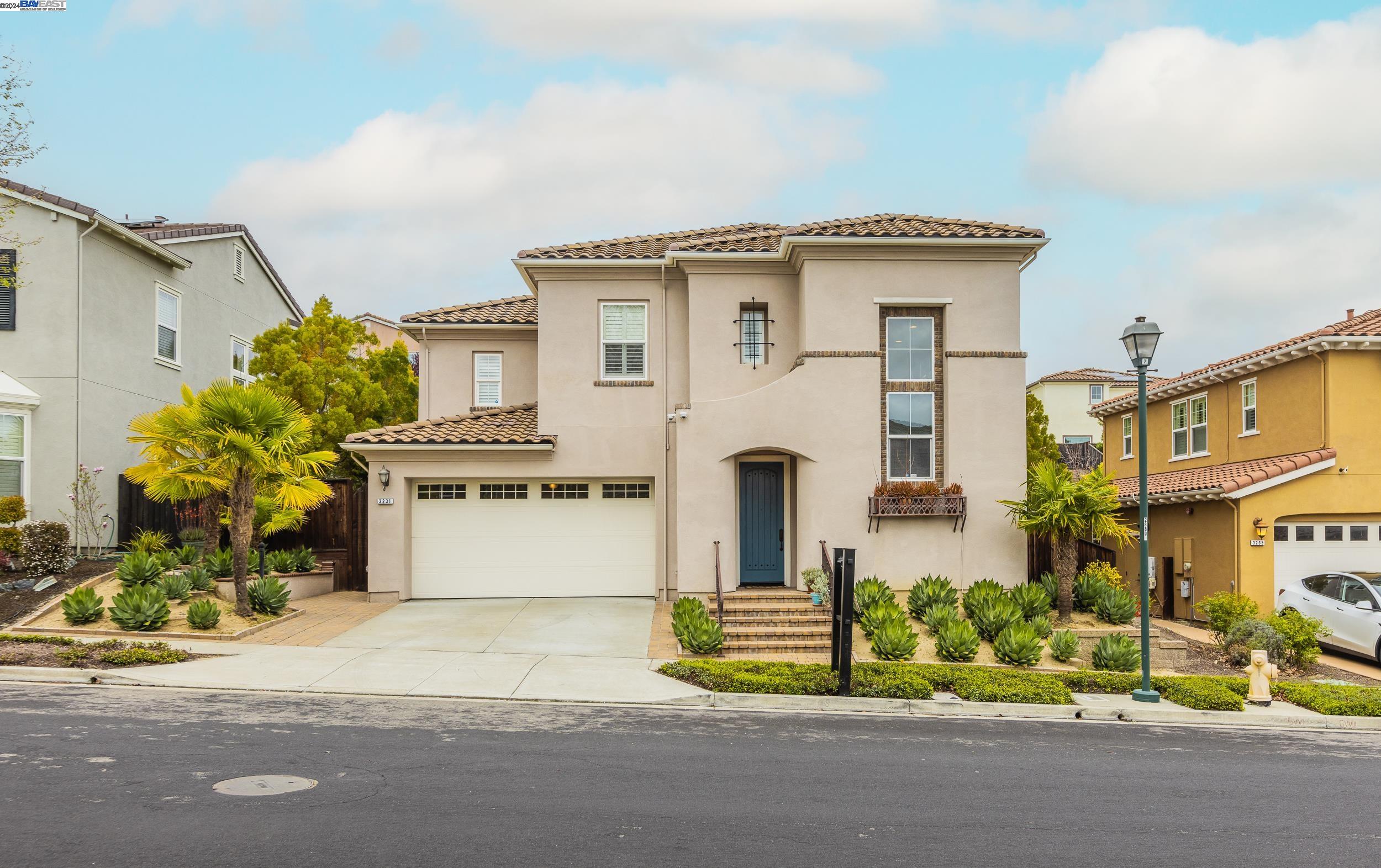 a front view of a house with a yard and a garage