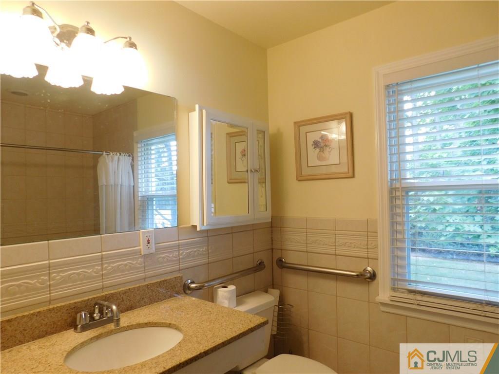 18 Lynnwood Road Edison, NJ 08820 - Photo 14 of 25 a bathroom with a granite countertop sink mirror vanity and toilet