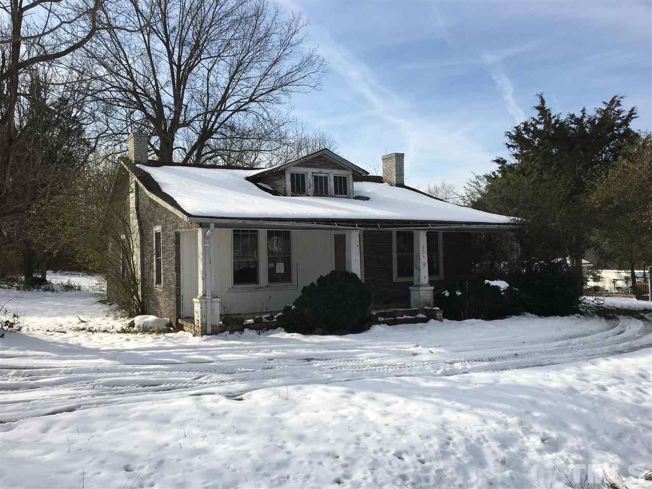 454 Providence Road Roxboro, NC 27573 - Photo 2 of 4 a front view of a house with a yard covered in snow