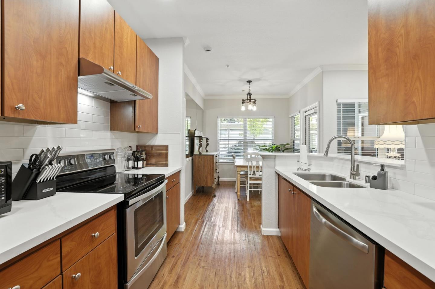 a kitchen with stainless steel appliances a sink stove and cabinets