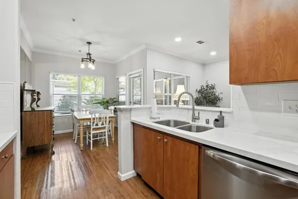a kitchen with a sink and wooden floor