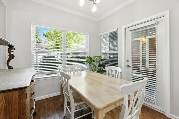 a view of a dining room with furniture and wooden floor