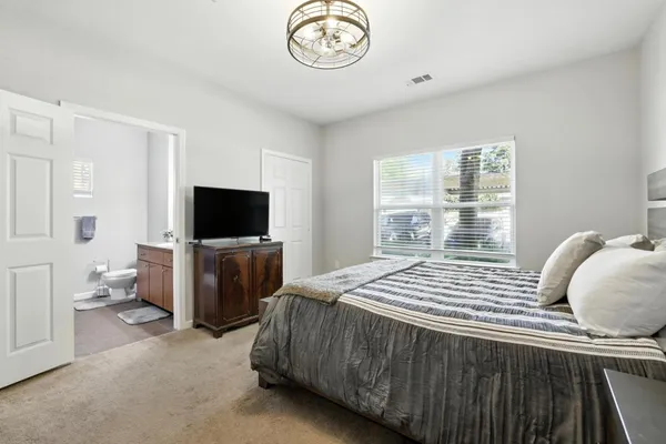 a bedroom with a bed and a television