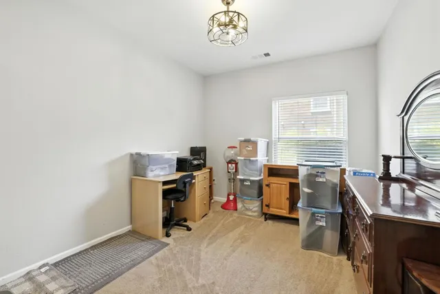 a view of a workspace with furniture and a window