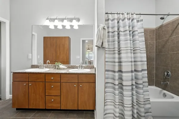 a bathroom with a double vanity sink and a mirror