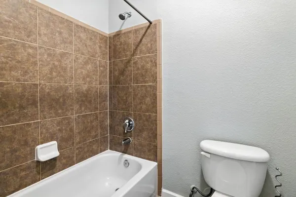 a bathroom with a toilet and a bathtub