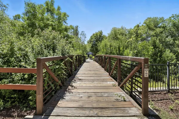 a view of balcony with wooden floor and fence