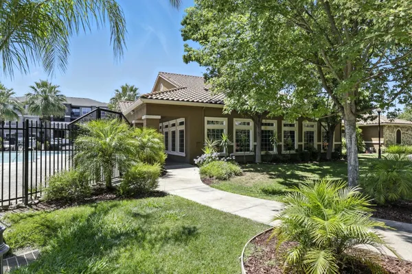 a view of a house with a small yard and plants